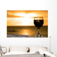 Glass of wine on the beach Wall Mural
