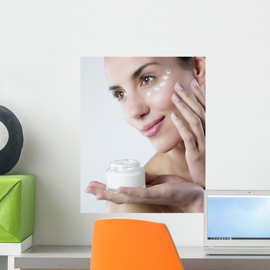 young woman smiling face care cream Wall Mural