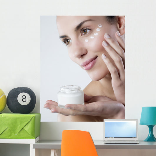 young woman smiling face care cream Wall Mural