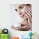young woman smiling face care cream Wall Mural