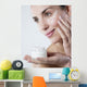 young woman smiling face care cream Wall Mural