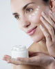 young woman smiling face care cream Wall Mural