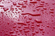 Liquid Drops On Red Surface Wall Mural