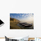 Boats Moored On River In A Row Outside City Wall Mural