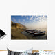 Boats Moored On River In A Row Outside City Wall Mural