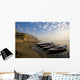 Boats Moored On River In A Row Outside City Wall Mural