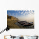 Boats Moored On River In A Row Outside City Wall Mural