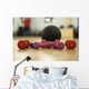 Dumbbells and ball on the floor of a fitness room Wall Mural