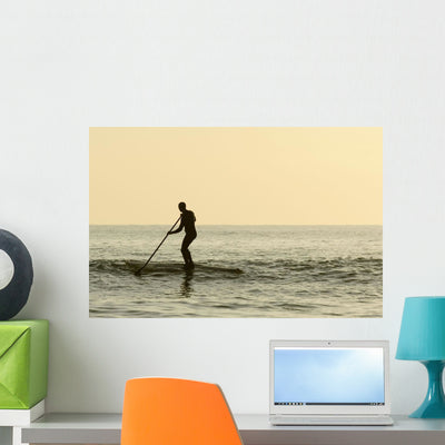 Surfer Steering into Shore Wall Mural shown on a wall