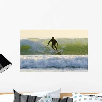 Surfer Catching Wave Wall Mural shown on a wall