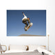 Low Angle View Of Young Male Skateboarder Wall Mural