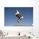 Low Angle View Of Young Male Skateboarder Wall Mural
