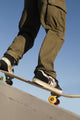 Low Angle View Of Young Male Skateboarder Wall Mural