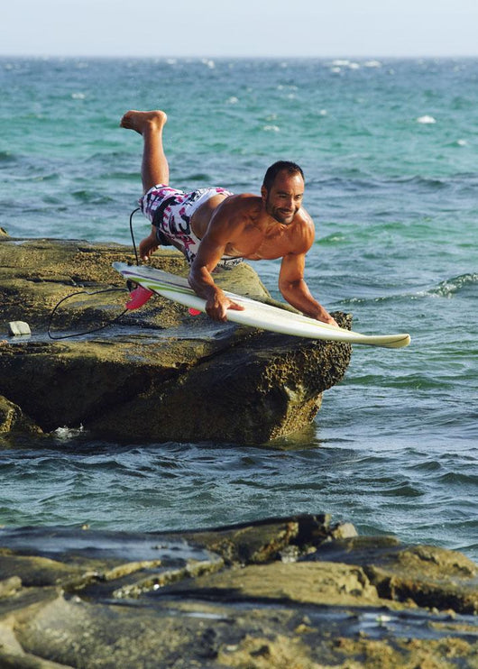 Man Jumping Into The Water On His Surf Board Wall Mural