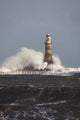 Waves Crashing Against A Lighthouse Wall Mural