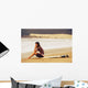 Young Woman Sitting On Her Surf Board On The Beach Wall Mural