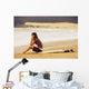 Young Woman Sitting On Her Surf Board On The Beach Wall Mural