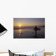 Silhouetted Surfer On Sandy Beach At Sunset Wall Mural