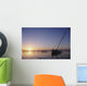 Partly Submerged And Keeling Sail Boat In Silhouette At Sunset Wall Mural