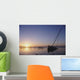 Partly Submerged And Keeling Sail Boat In Silhouette At Sunset Wall Mural