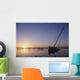 Partly Submerged And Keeling Sail Boat In Silhouette At Sunset Wall Mural