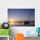 Partly Submerged And Keeling Sail Boat In Silhouette At Sunset Wall Mural