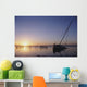 Partly Submerged And Keeling Sail Boat In Silhouette At Sunset Wall Mural