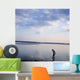 Boy In Silhouette Wading In Ocean Wall Mural