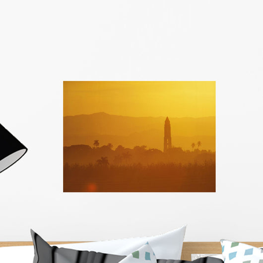 Tower Silhouetted Amongst Orange Mountains Wall Mural