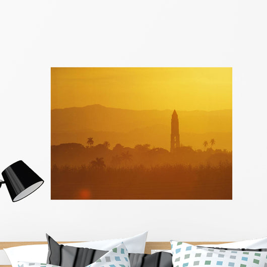 Tower Silhouetted Amongst Orange Mountains Wall Mural