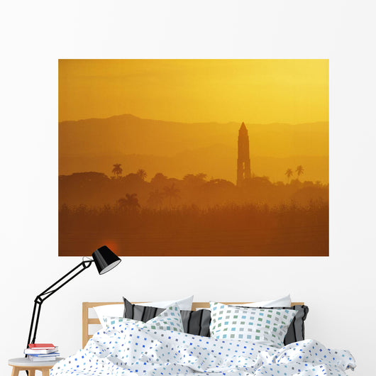 Tower Silhouetted Amongst Orange Mountains Wall Mural