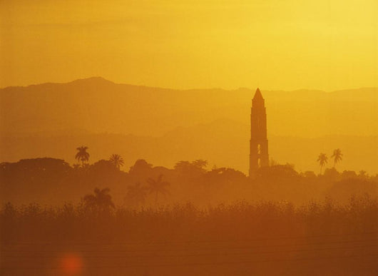 Tower Silhouetted Amongst Orange Mountains Wall Mural