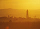 Tower Silhouetted Amongst Orange Mountains Wall Mural