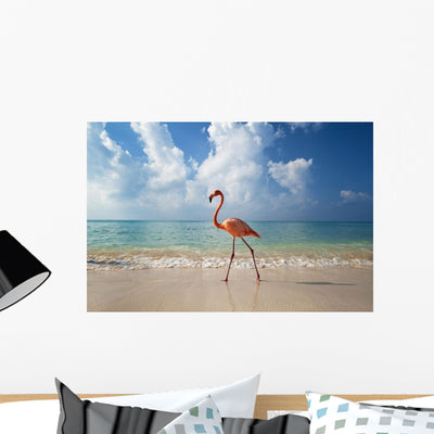 Flamingo Walking along Beach Wall Mural shown on a wall