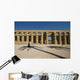 Man Walking Past Shadow Of Date Palm In Forecourt Wall Mural