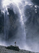 Walker Beneath Waterfall In The Cirque De Gavarnie Wall Mural