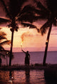 Native In A Grass Skirt Holding A Flaming Torch By Coast At Sunset Wall Mural