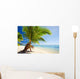 Small palm tree hanging over stunning lagoon Wall Mural