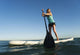 A Woman Paddling While Standing On A Surf Board Off Dos Mares Beach Wall Mural