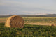 Hay Bales In A Field With Mountains In The Background At Sunrise Wall Mural