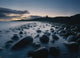 Large Boulders On Beach Near Dunstanburgh Castle At Dawn Wall Mural