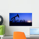 Silhouette of oil pump jacks with sunset Wall Mural