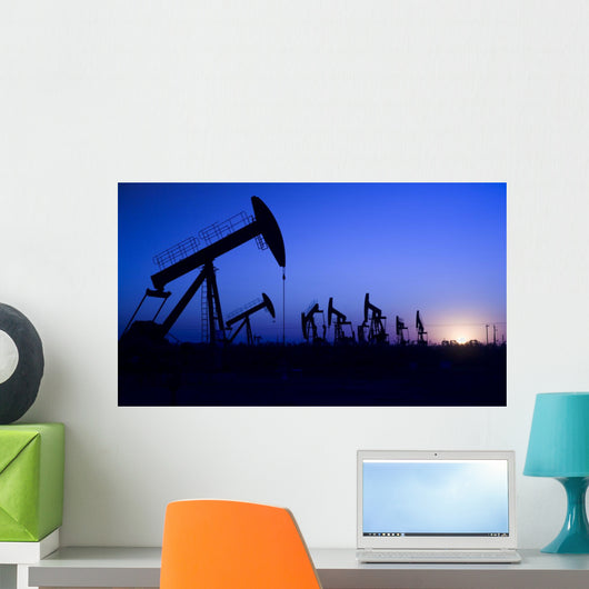 Silhouette of oil pump jacks with sunset Wall Mural