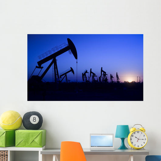 Silhouette of oil pump jacks with sunset Wall Mural