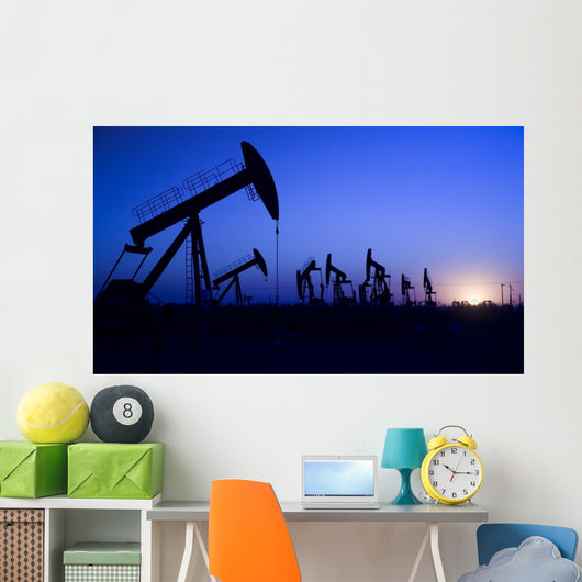 Silhouette of oil pump jacks with sunset Wall Mural