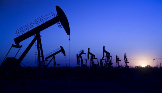 Silhouette of oil pump jacks with sunset Wall Mural