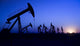Silhouette of oil pump jacks with sunset Wall Mural