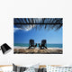 Two Chairs On Deck By Ocean Shaded By Grass Roof Wall Mural