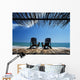 Two Chairs On Deck By Ocean Shaded By Grass Roof Wall Mural