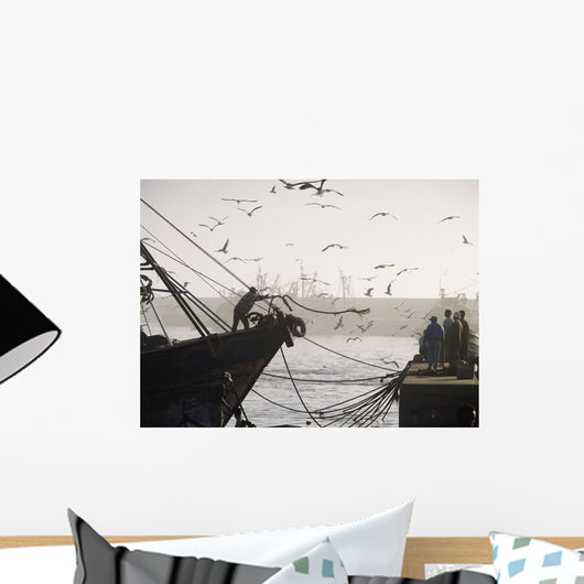 Man Throwing Rope To People On Dockside Of Harbor At Dusk Wall Mural